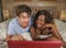 Young happy and attractive multiracial couple with beautiful black afro American ethnicity woman and white man lying relaxed on