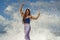 Young happy and attractive red hair woman playing excited spreading arms feeling free and relaxed getting wet by sea waves