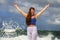 Young happy and attractive red hair woman playing excited spreading arms feeling free and relaxed getting wet by sea waves