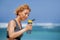 Young happy and attractive sport runner woman drinking water bottle or isotonic drink after running workout at tropical paradise b