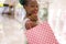 Young happy and beautiful afro American girl at buying shopping mall - lifestyle portrait of millennial black girl enjoying