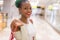 Young happy and beautiful afro American girl at buying shopping mall - lifestyle portrait of millennial black girl enjoying