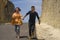 Young happy and beautiful Asian Chinese couple in love enjoying outdoors journey running playful in cliff rock road exploring the