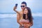 young happy and beautiful Asian Chinese couple taking selfie pho