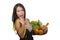 Young happy and beautiful Asian Chinese woman holding basket full of vegetables and fruits smiling cheerful holding measure taylor