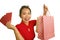 Young happy and beautiful Asian Chinese woman in red dress smiling cheerful holding shopping bags as excited spending money after