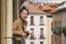 Young happy and beautiful Asian Japanese woman enjoying city view from hotel room balcony in Spain during holidays trip in Europe