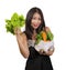 Young happy and beautiful Asian Korean woman holding bag full of vegetables smiling cheerful holding green lettuce in healthy