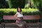 Young happy and beautiful Asian Korean woman pregnant showing her belly proud and cheerful smiling at city park bench happy in