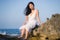 Young happy and beautiful Asian woman by the sea - Attractive Chinese girl in white dress enjoying relaxed summer holidays at