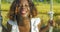 Young happy and beautiful black African American woman in Summer dress playing outdoors on swing smiling cheerful and relaxed