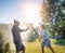 Young happy beautiful couple hosing in the garden, summer happiness and love concept, poured water from a garden hose of a spray