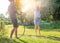 Young happy beautiful couple hosing in the garden, summer happiness and love concept, poured water from a garden hose of a spray