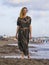 Young happy beautiful and glamorous blond woman posing as at the beach wearing stylish dress smiling cheerful feeling fresh and fr