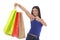 Young happy and beautiful hispanic woman holding color shopping bags smiling excited isolated