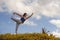 Young happy and beautiful red hair woman sitting on green field relaxed on grass practicing yoga balance and acroyoga exercise