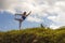 Young happy and beautiful red hair woman sitting on green field relaxed on grass practicing yoga balance and acroyoga exercise