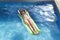 Young happy beautiful woman in bikini and sunglasses lying relax on float airbed at vacation hotel resort swimming pool