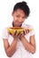 Young happy black / african american woman holding fresh papaya