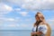 Young happy blond woman at beautiful tropical paradise view of ocean enjoying summer holidays