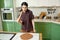 Young happy brunette mestizo woman cooking gingerbread homemade cookies in home kitchen