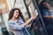 Young happy businesswoman outside the office building, enters the building