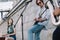 Young happy buskers with guitar drum and saxophone