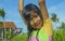 Young happy and carefree beautiful child 7 or 8 years old outdoors having shower at a beautiful rice terrace playful under the