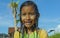 Young happy and carefree beautiful child 7 or 8 years old outdoors having shower at a beautiful rice terrace playful under the