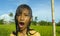 Young happy and carefree beautiful child 7 or 8 years old outdoors having shower at a beautiful rice terrace playful under the