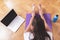 Young happy Caucasian woman, stretching in the living room while looking at her laptop. Health care and wellness at home concept