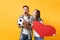 Young happy cheerful couple supporter, woman man, football fans cheer up support team, holding red heart love, soccer