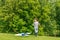 Young happy child boy playing with bright kite in park