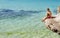 Young happy child boy on rocks on tropical sea backgroun