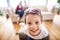 Young happy child with parents in the background packing for holidays.