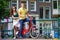 Young happy couple on bikes at bridge in Amsterdam
