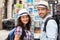 Young happy couple choosing postcards during holidays