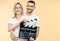 Young happy couple with cinema clapper board