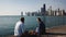 Young happy couple enjoying romantic date on the shore of Michigan lake with panoramic view of Chicago, America.