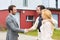 Young happy couple handshaking real estate agent after signing contract