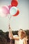 Young happy couple holding colorful ballons and smiling