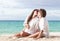 Young happy couple kissing at tropical beach. honeymoon