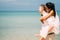 Young happy couple man and woman in white clothes on beach portrait