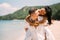 Young happy couple man and woman in white clothes on beach portrait