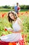 Young happy couple on a meadow full of poppies