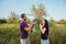 Young happy couple on nature,the boy gives girl a dog - yorkshire terrier as gift