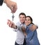 Young happy couple receiving house key new residence in real state concept