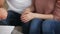 Young happy couple shaking hands with broker, close up