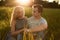 Young happy couple sitting together on grass holding their hands