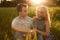 Young happy couple sitting together on grass holding their hands